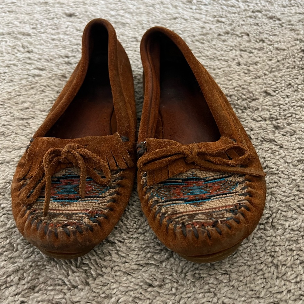 Minnetonka moccasins with tribal detail on front